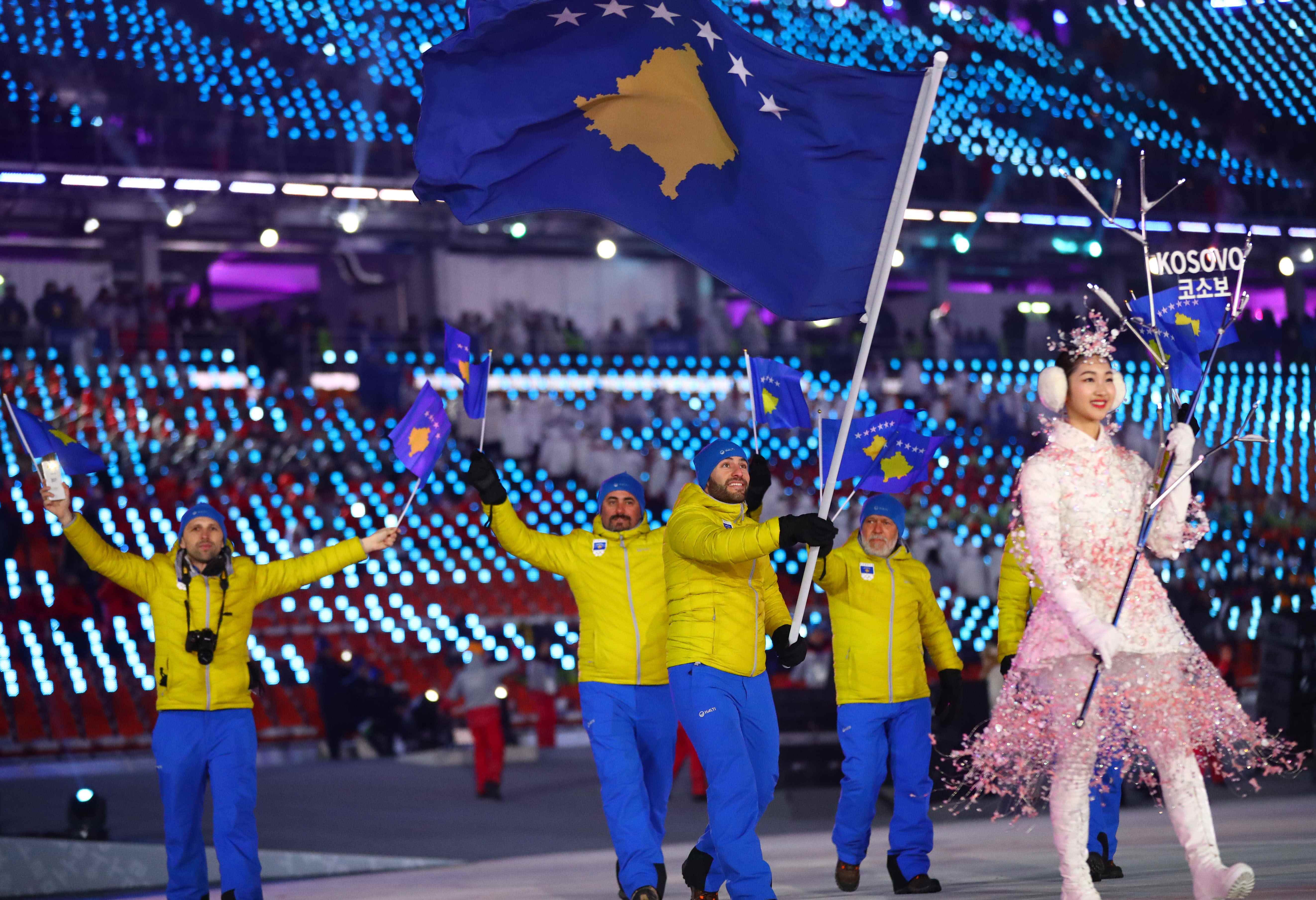 Kosovar athletes carry the national flag during the opening ceremony of the 2018 Winter Olympics (by Reuters)
